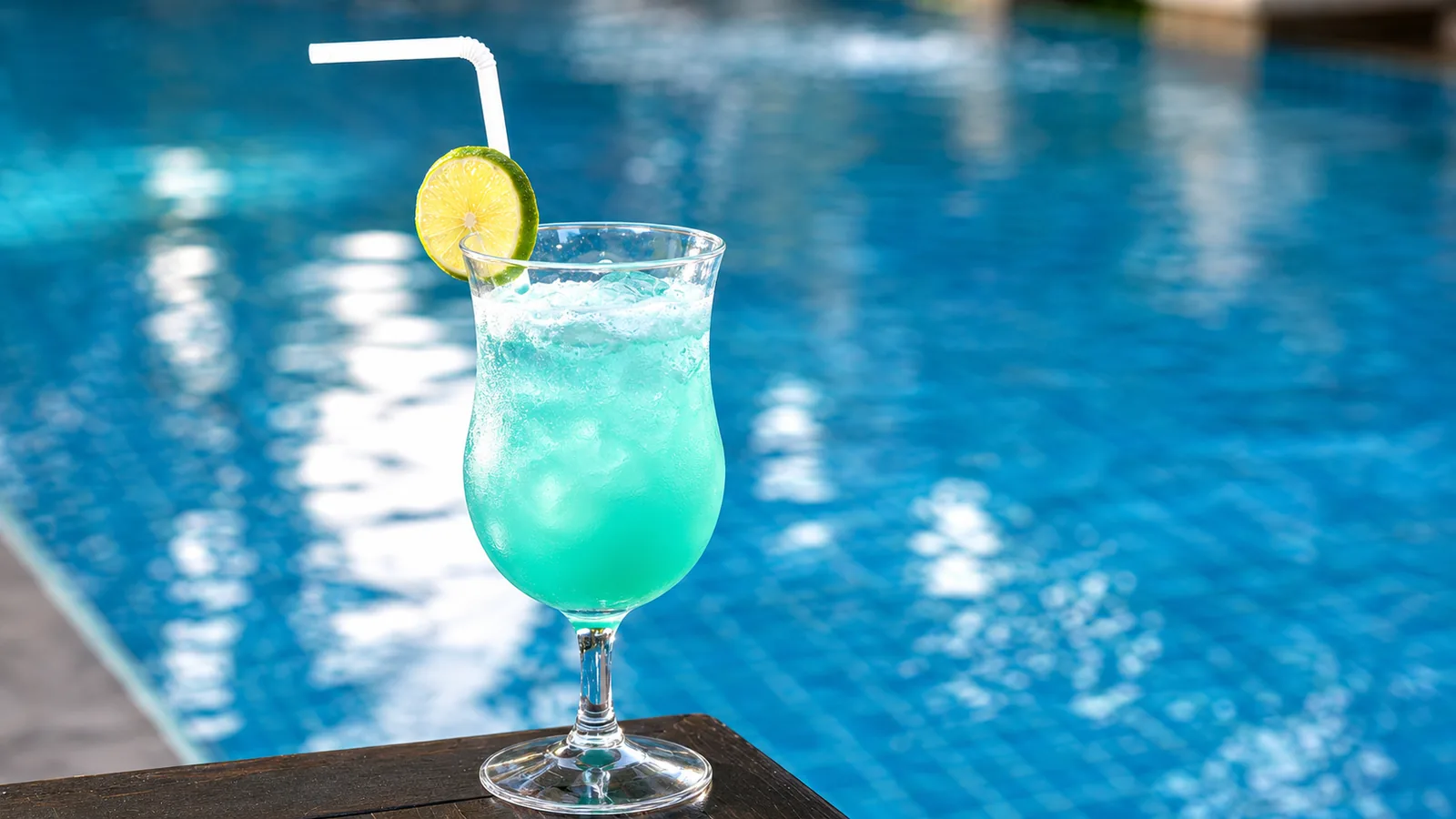 Refreshing blue drink by the swimming pool